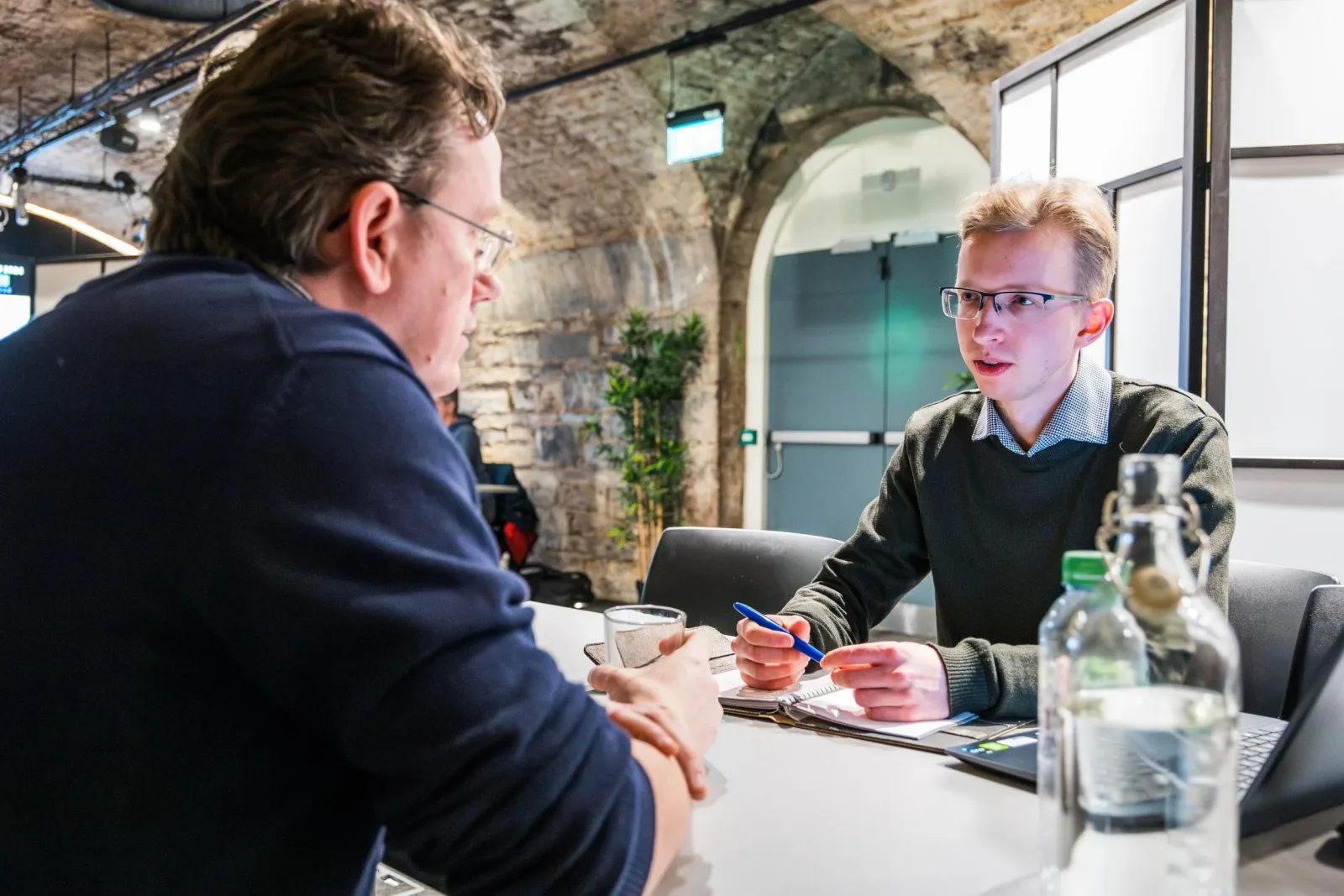 Two people speaking across a table at an NDRC mentorship event