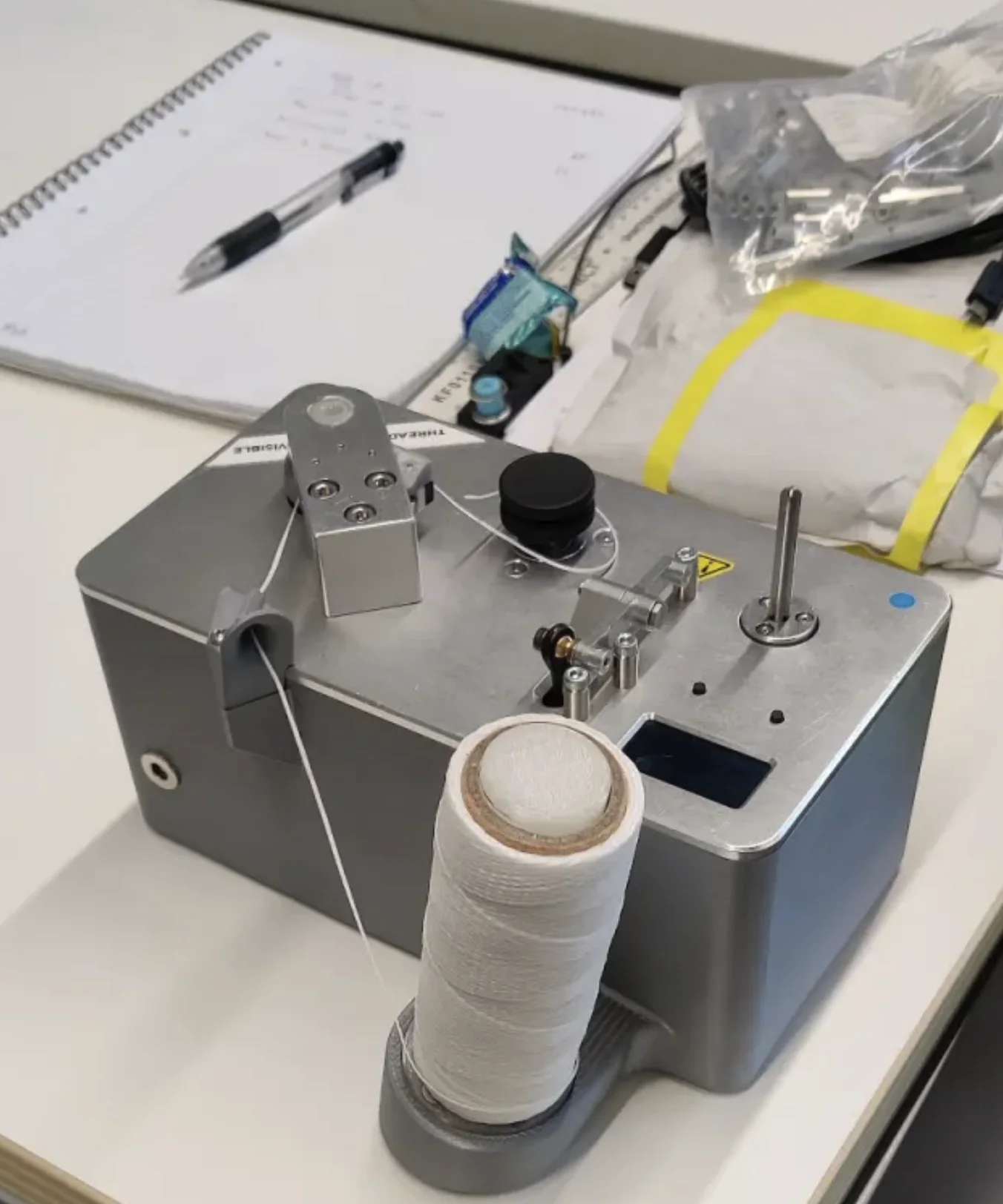 Spooling machine with a finished spool on a workbench
